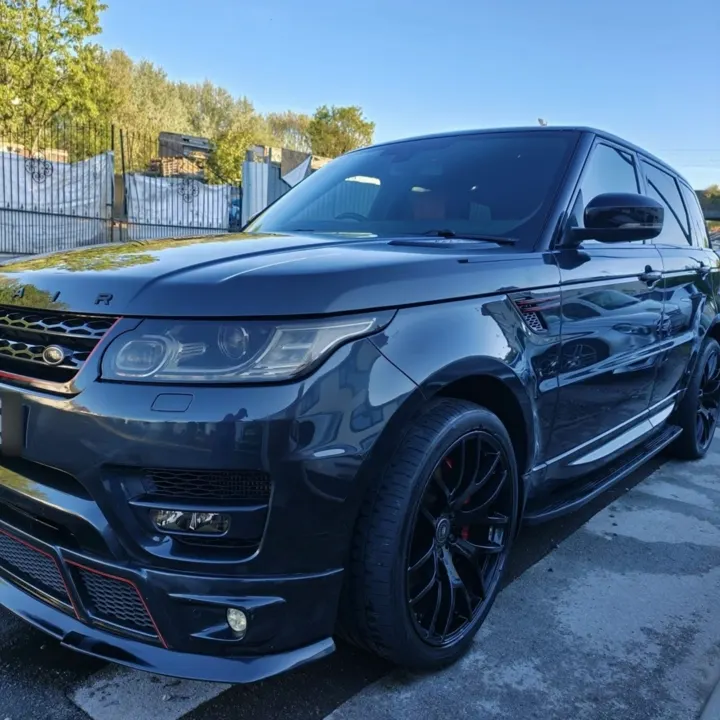Dark grey Range Rover Sport parked outdoors in sunshine