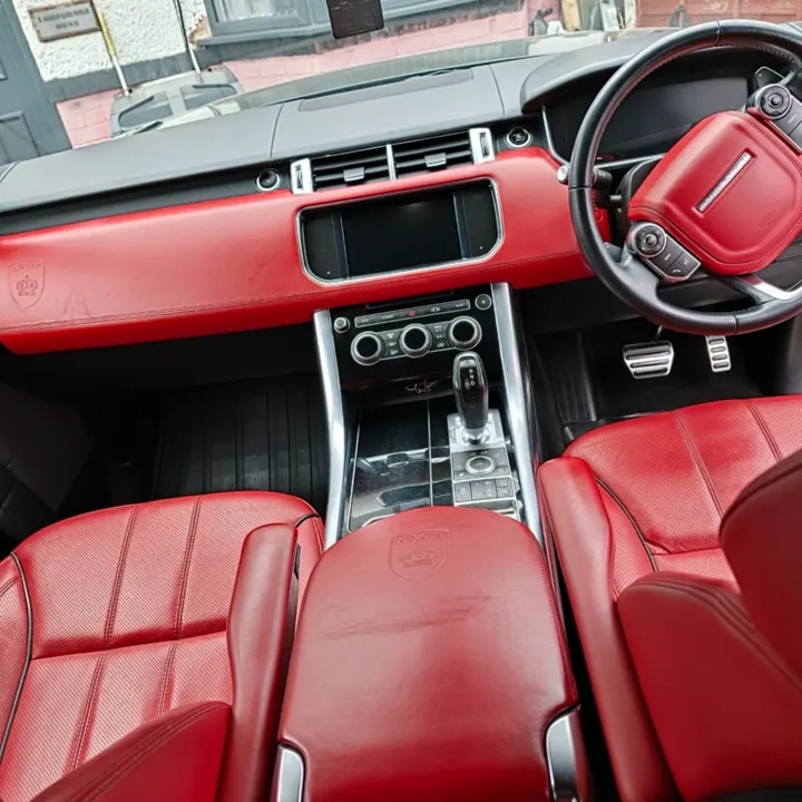 Range Rover interior with red leather seats and dashboard