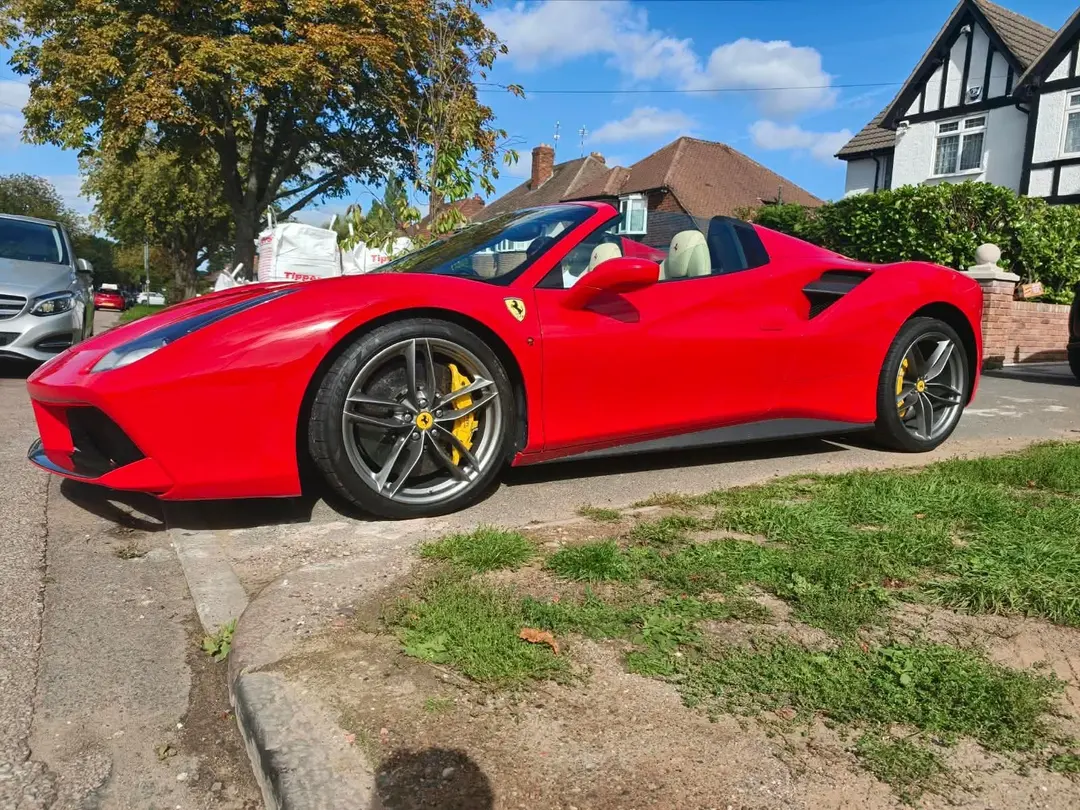 Red Ferrari 488 Spider parked kerbside on a sunny day